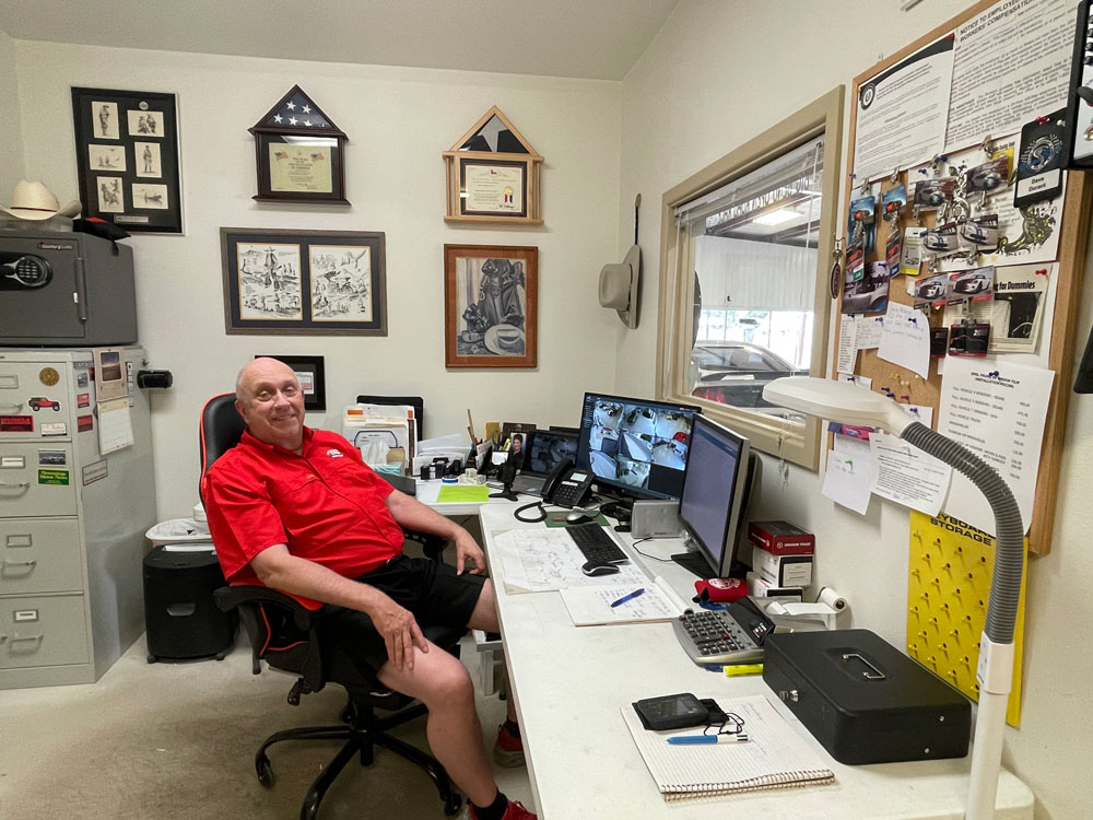Dave Durant, owner of The Stable Performance Cars in Alpine, TX, relaxes in his office.