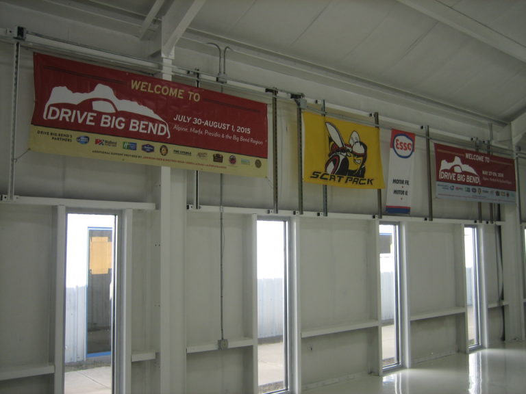 Banners hung in the new building at The Stable Performance Cars in Alpine, TX