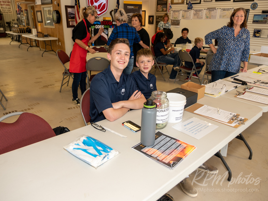 Students from the Alpine Christian School help with registration at the Law Enforcement Appreciation Dinner at The Stable Performance Cars during Octane Fest.