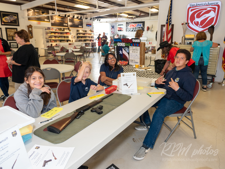 Students from the Alpine Christian School sell raffle tickets at the Law Enforcement Appreciation Dinner at The Stable Performance Cars during Octane Fest.