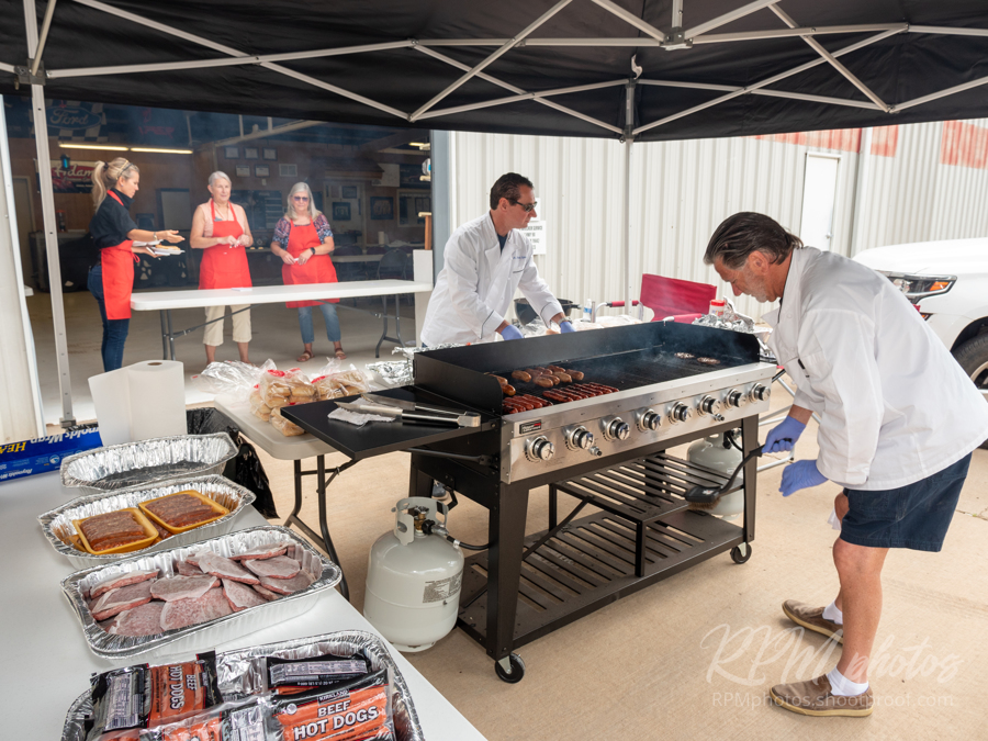 Burgers and fajitas are prepared for the Law Enforcement Appreciation Dinner at The Stable Performance Cars during Octane Fest.