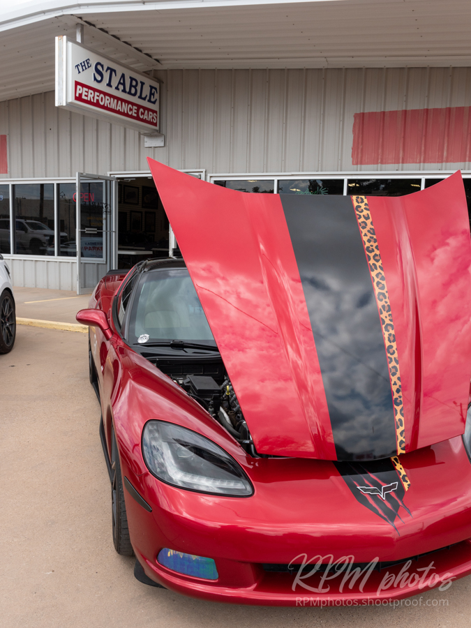 A red Corvette parked at The Stable Performance Cars during Octane Fest.