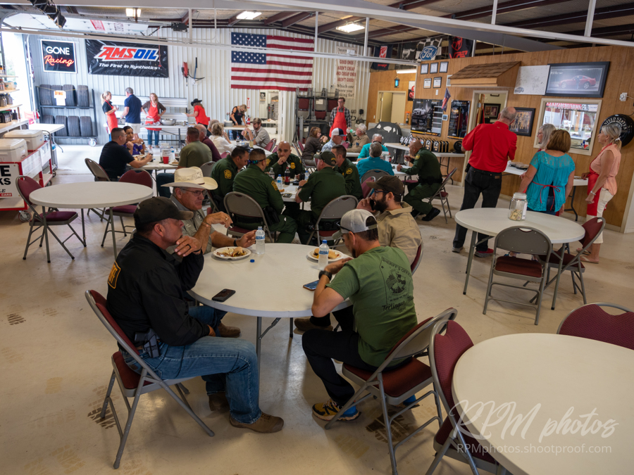 People enjoy burgers and fajitas during the Law Enforcement Appreciation Dinner at The Stable Performance Cars during Octane Fest.