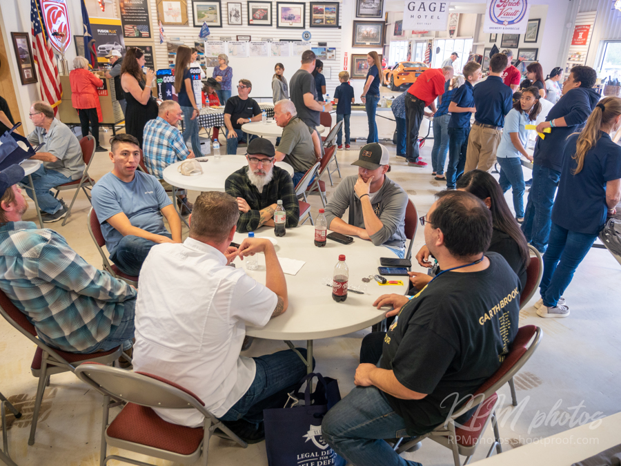 People wait for burgers and fajitas during the Law Enforcement Appreciation Dinner at The Stable Performance Cars during Octane Fest.