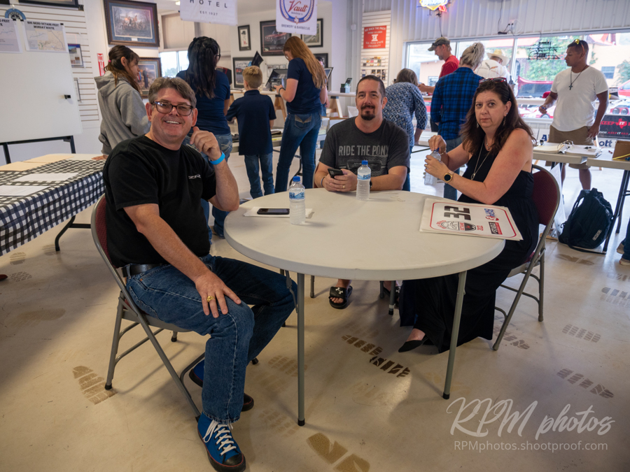 People wait for burgers and fajitas during the Law Enforcement Appreciation Dinner at The Stable Performance Cars during Octane Fest.