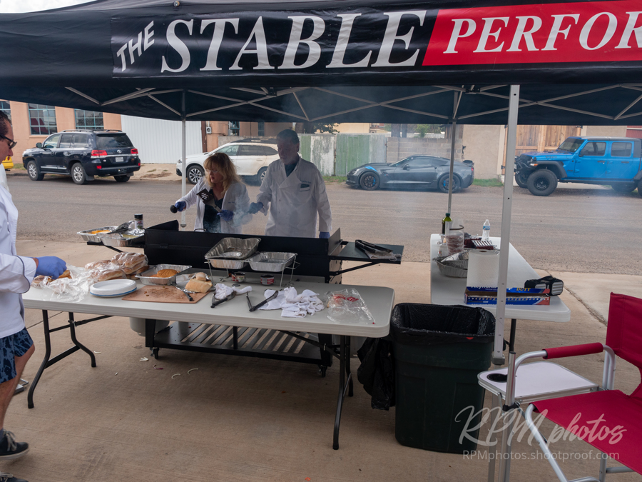Burgers and fajitas are grilled by volunteers for the Law Enforcement Appreciation Dinner at The Stable Performance Cars during Octane Fest.