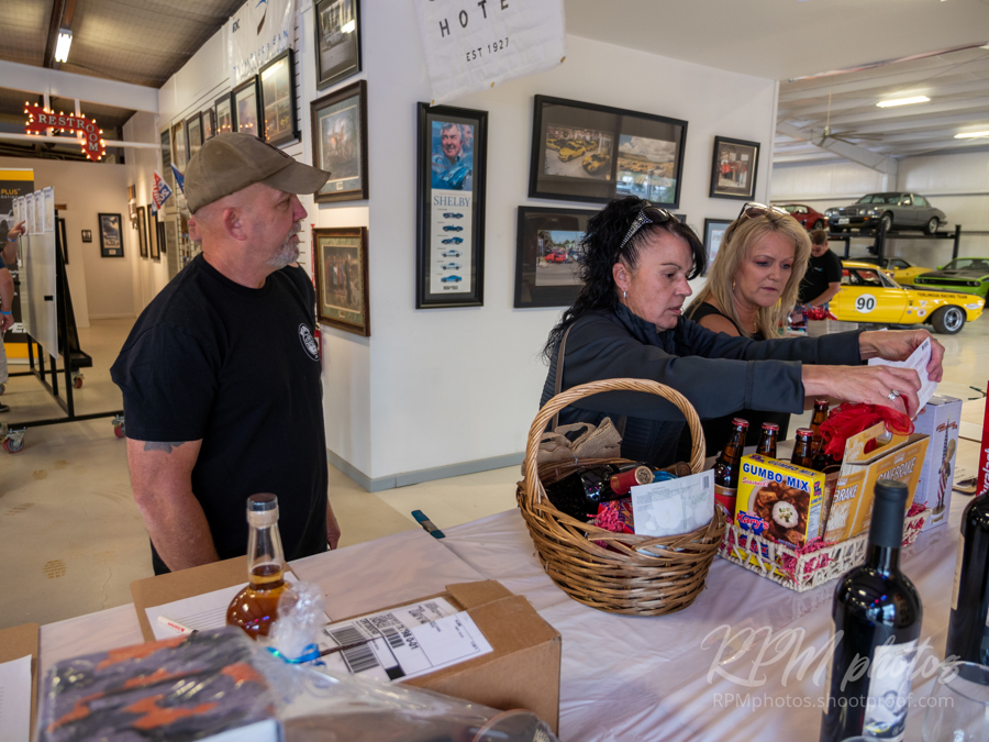 People place bids on the Silent Auction at The Stable Performance Cars during Octane Fest.