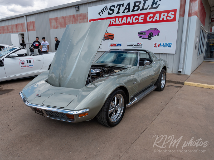 A gray-green mid-60's Corvette is shown at the car show at The Stable Performance Cars during Octane Fest.