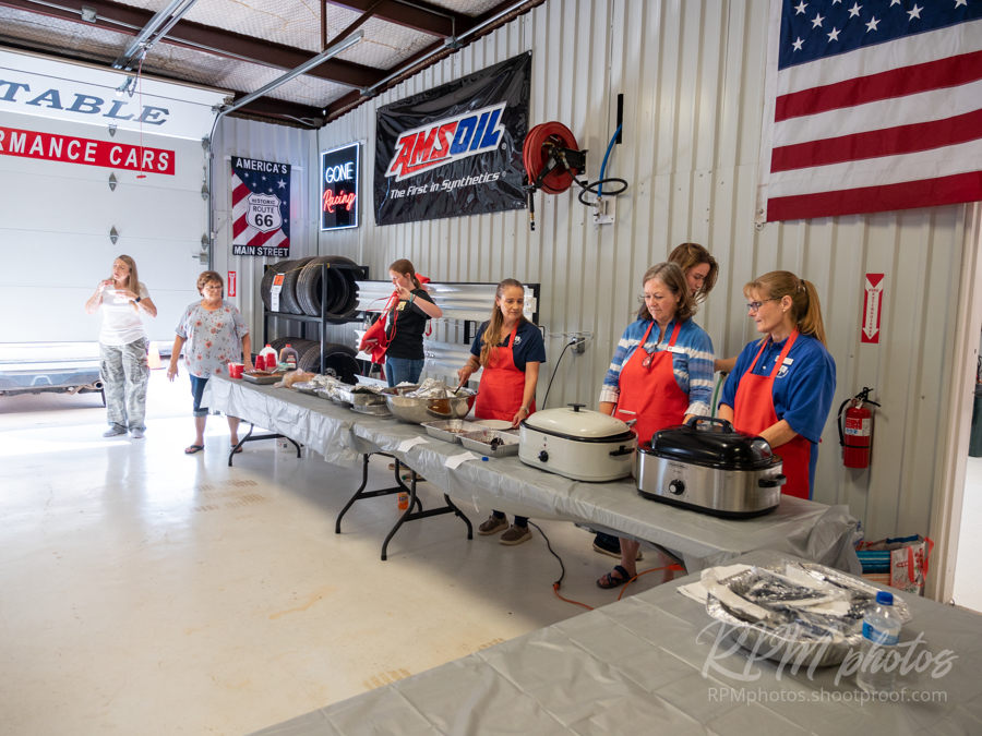 Volunteers from Alpine Christian School prepare to serve food at The Stable Performance Cars during Octane Fest.