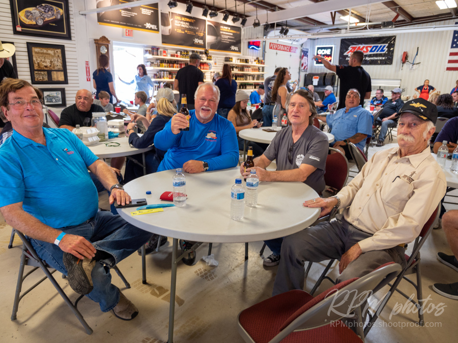 People enjoy a beer and conversation at The Stable Performance Cars during Octane Fest.