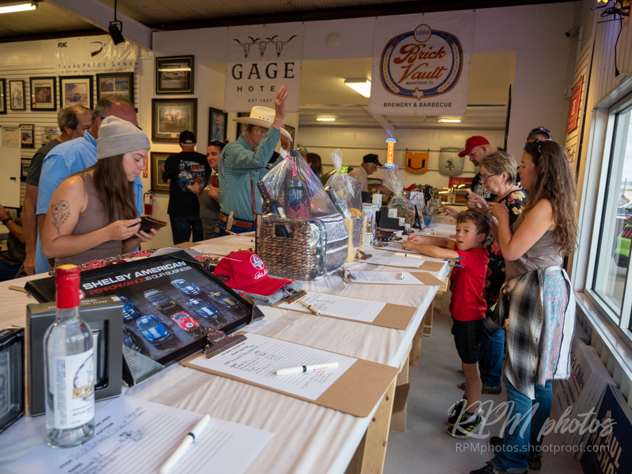 Various people place bids on the silent auction at Octane Fest.