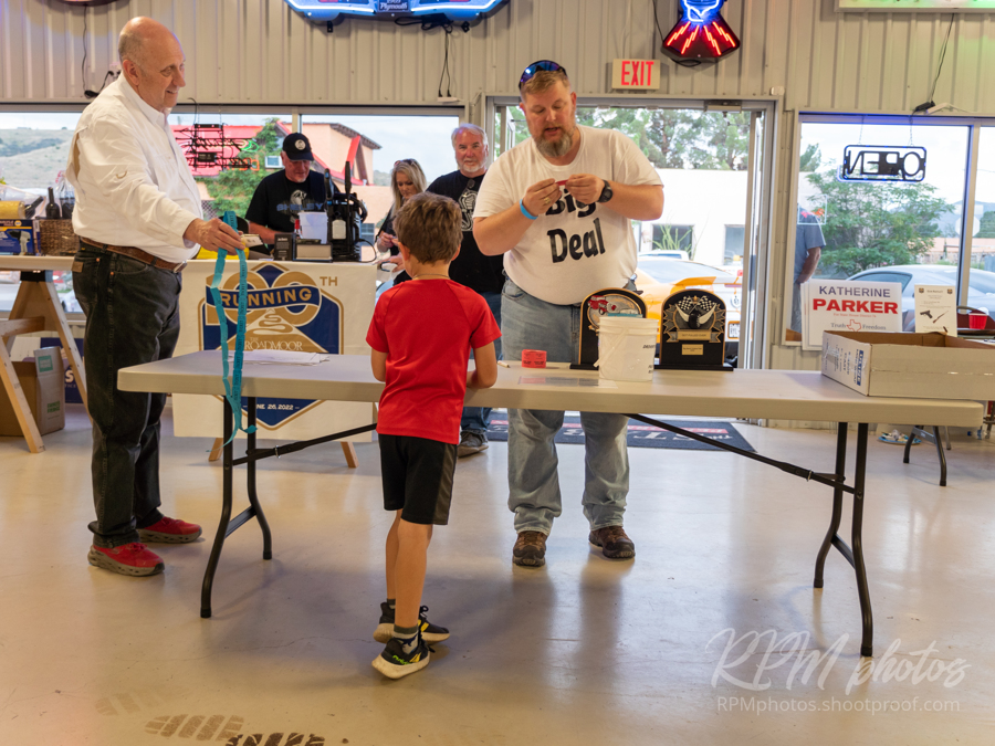Owner Dave Durant hands a young boy a string of door prize tickets.