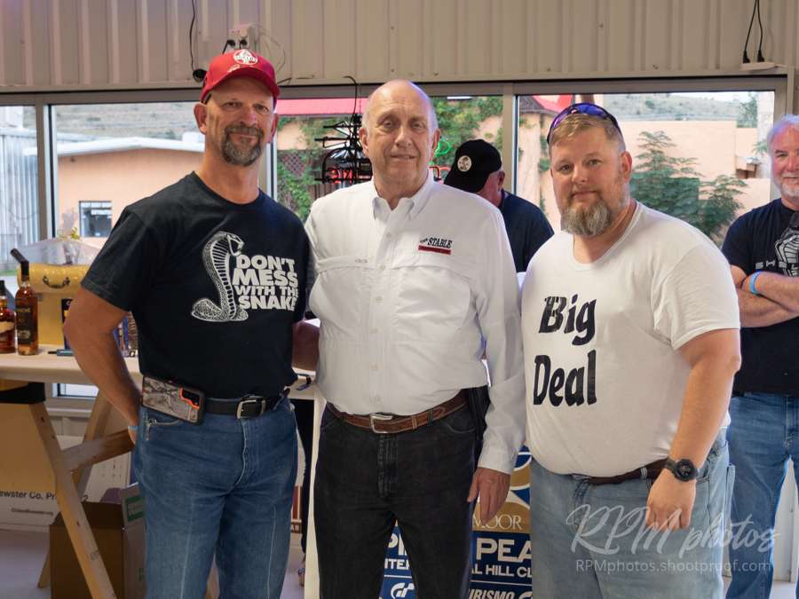 Owner Dave Durant stands between two men for a photo at Octane Fest.